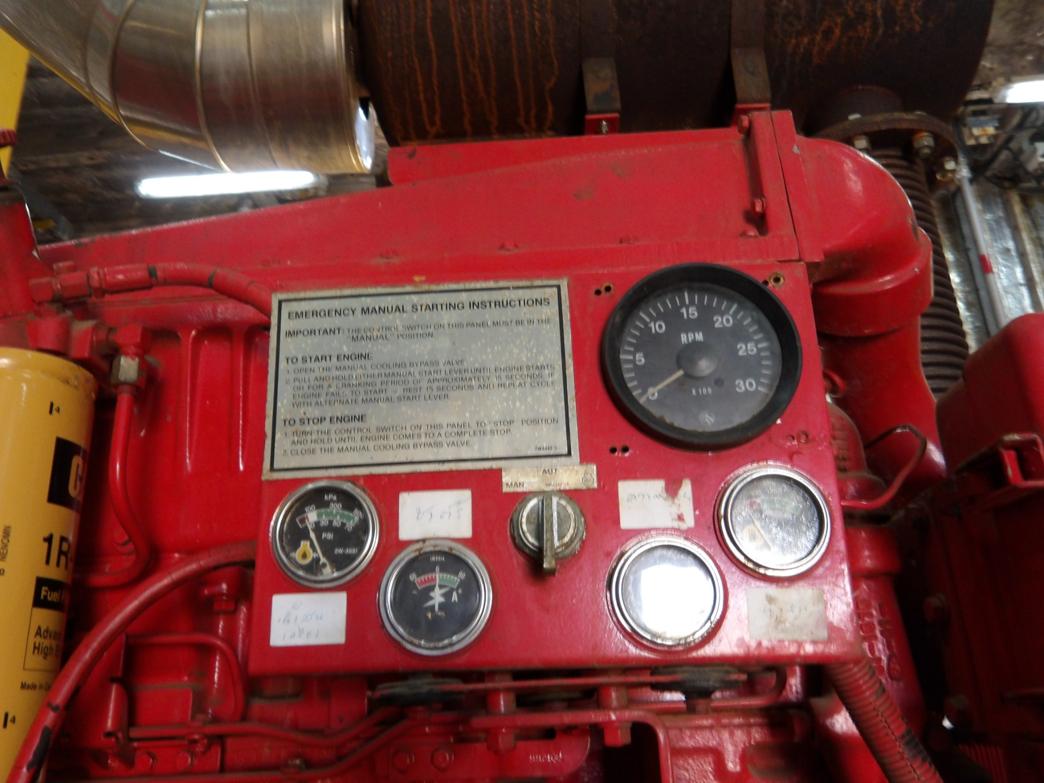 Diesel fire pump engine instrument panel during an annual NFPA 25 performance test — tachometer, oil pressure gauge, ammeter and manual/automatic selector switch